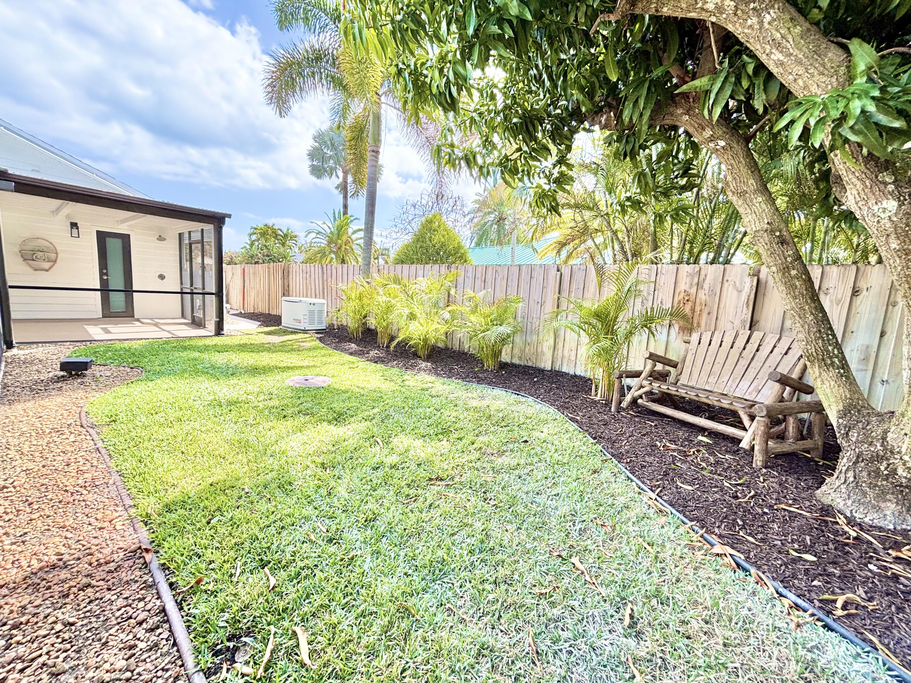 14 Southeast Paddock Circle Jupiter, FL 33469 - Photo 40 of 45 a view of a backyard with a garden