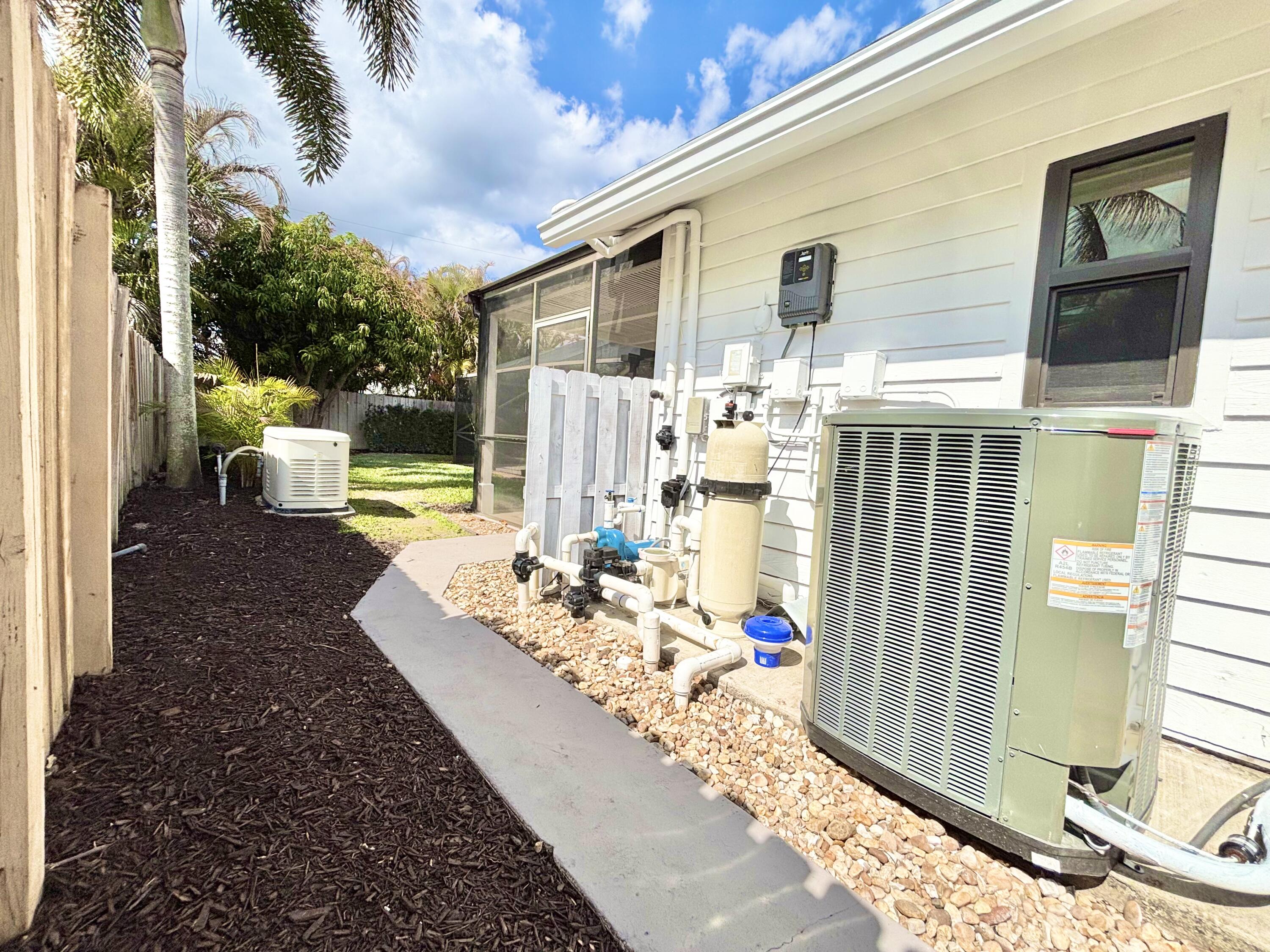14 Southeast Paddock Circle Jupiter, FL 33469 - Photo 41 of 45 a front view of a house with outdoor seating