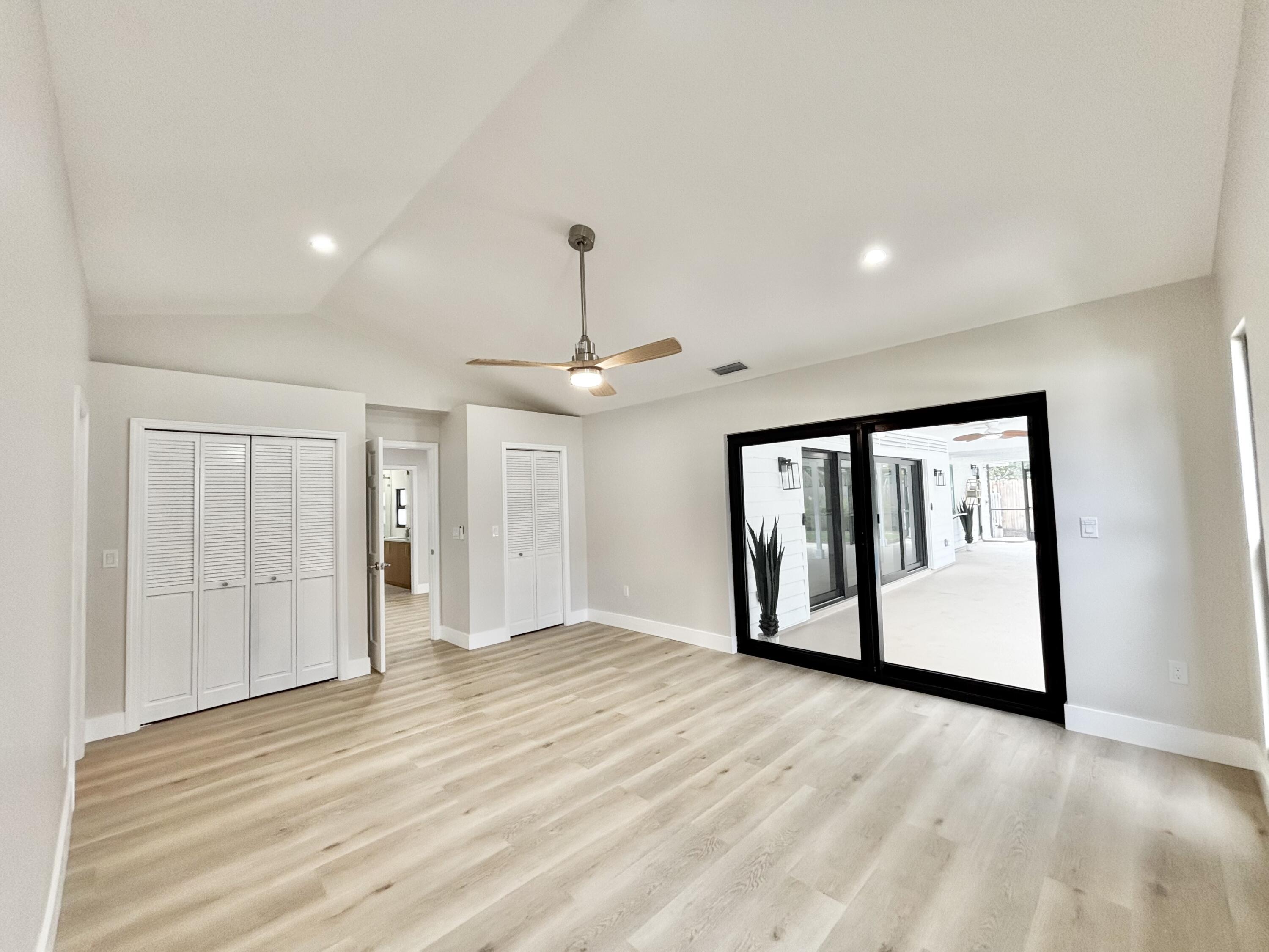 14 Southeast Paddock Circle Jupiter, FL 33469 - Photo 8 of 45 a view of empty room with wooden floor and window