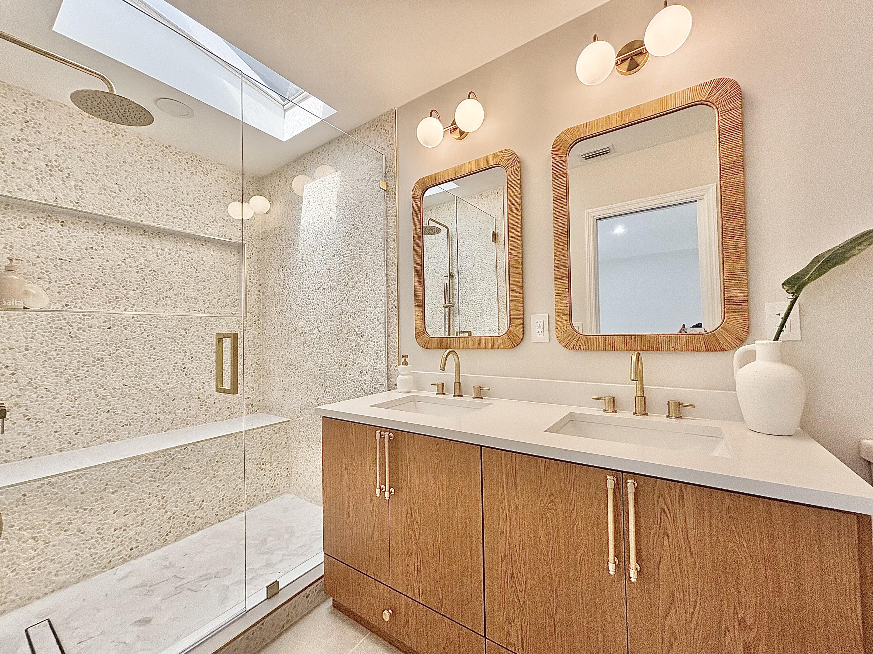 14 Southeast Paddock Circle Jupiter, FL 33469 - Photo 9 of 45 a bathroom with a double vanity sink and mirror