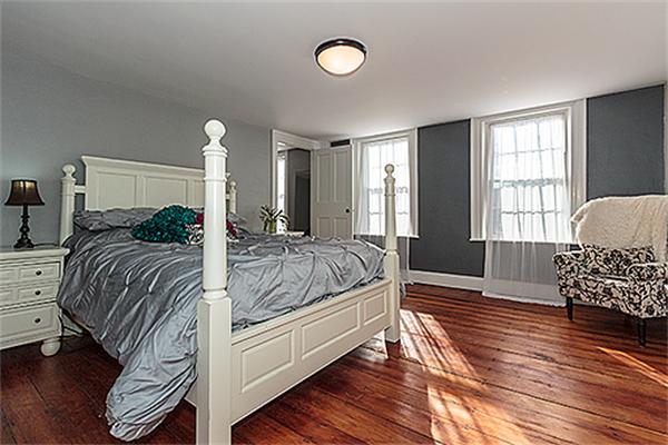 30 Cochituate Road Wayland, MA 01778 - Photo 17 of 30 a spacious bedroom with a bed a dresser and wooden floor