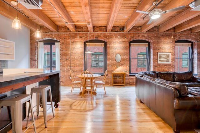 a living room with fireplace furniture and a wooden floor