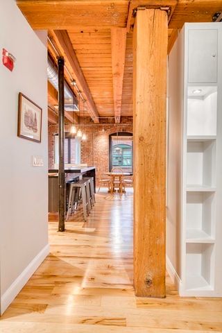 a view of a living room with kitchen and dining room