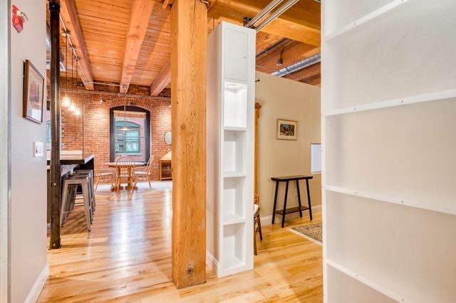 a view of living room with furniture and wooden floor