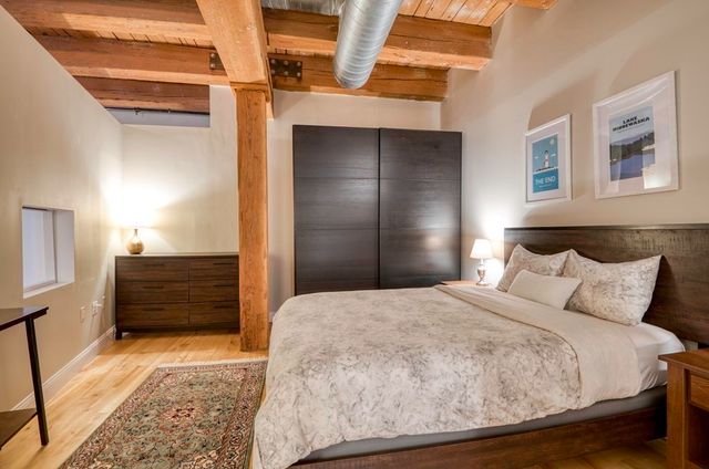 a bedroom with a bed and cabinets