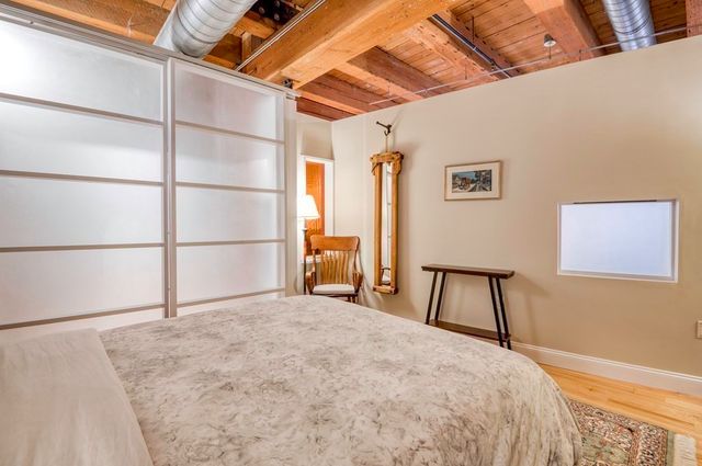 a large bed in a room next to a window