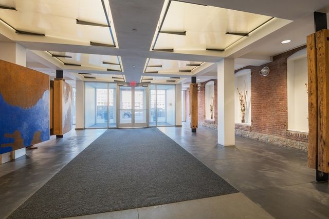 a view of an entryway with a floor to ceiling window and an entryway