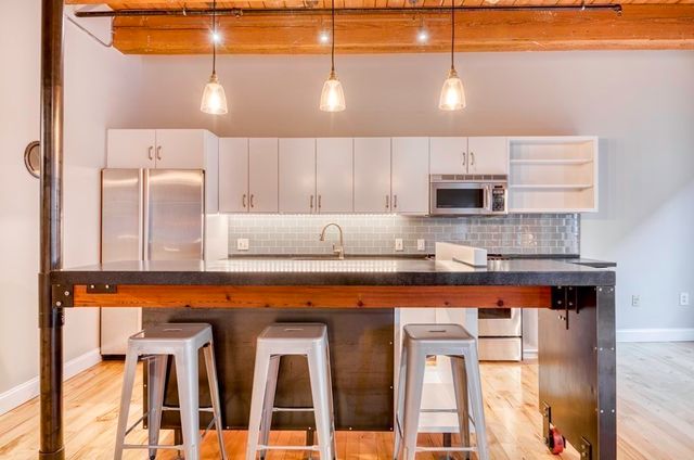 a kitchen with stainless steel appliances granite countertop a stove and a sink