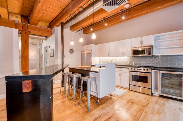 a kitchen with a stove a sink and a refrigerator