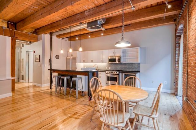 a dining room with furniture and wooden floor