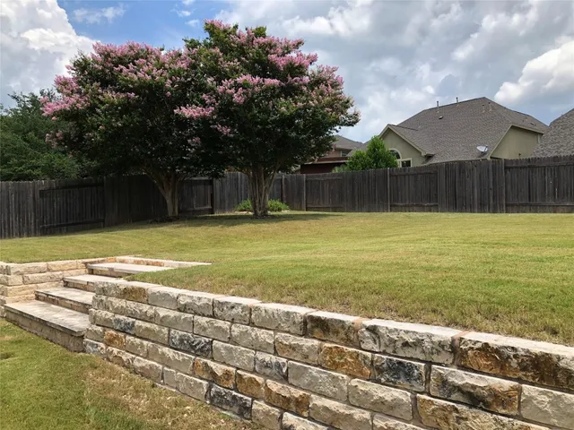 a view of a swimming pool and a yard
