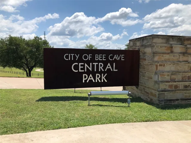 a sign that is sitting on the grass of the house