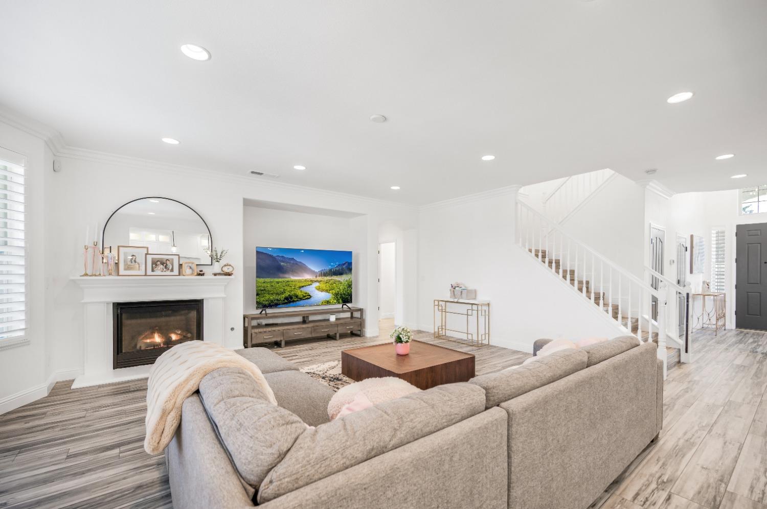 261 North Terry Avenue Clovis, CA 93612 - Photo 12 of 51 a living room with furniture a fireplace and a flat screen tv