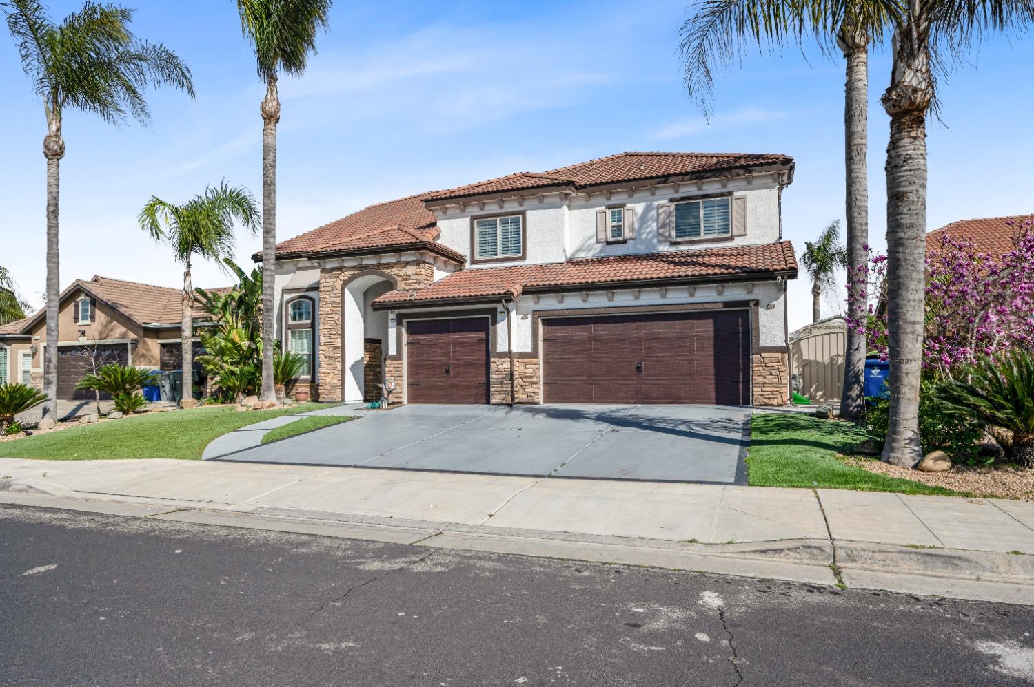 261 North Terry Avenue Clovis, CA 93612 - Photo 3 of 51 a front view of a house with a yard and garage