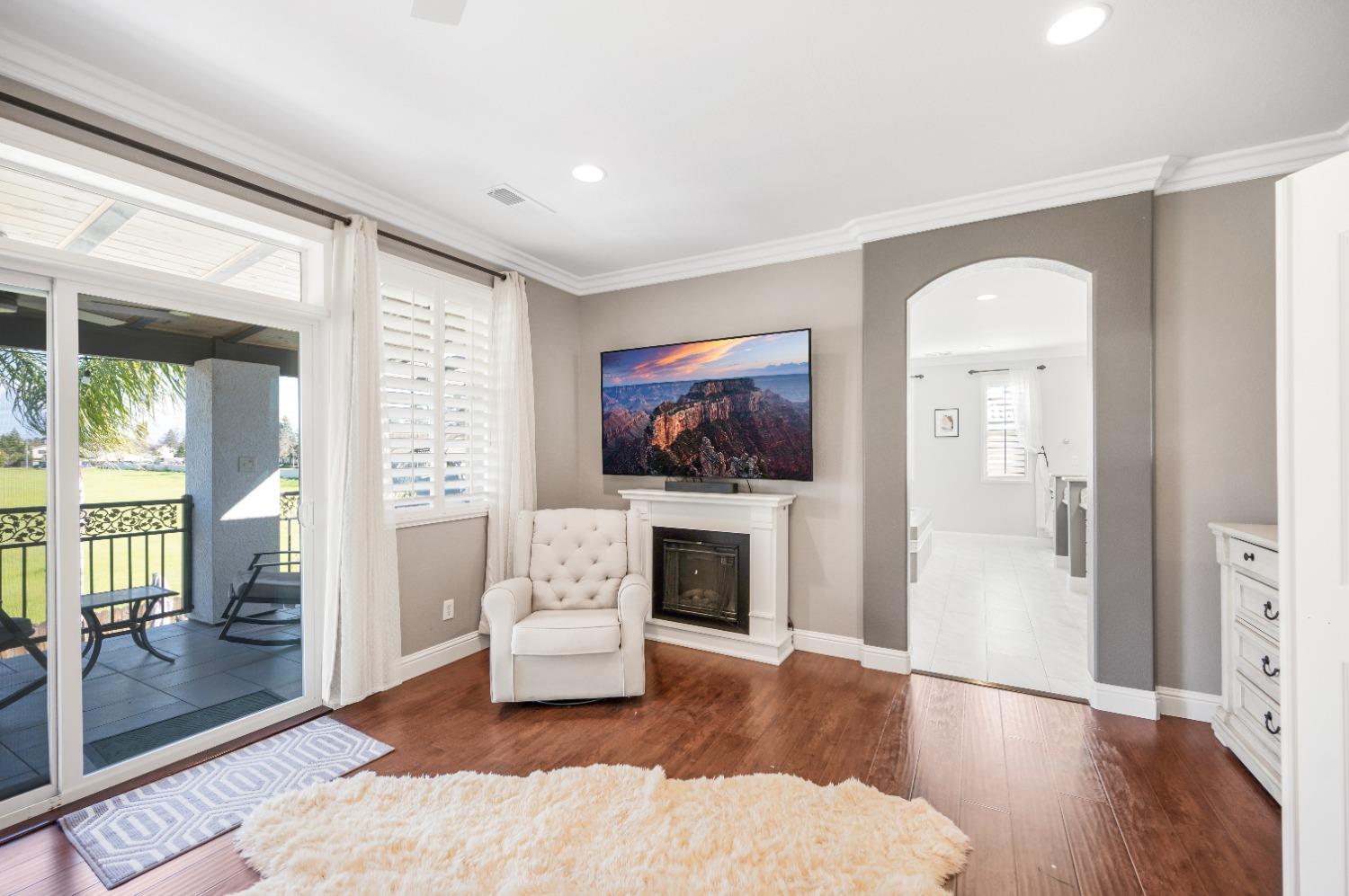 261 North Terry Avenue Clovis, CA 93612 - Photo 33 of 51 a living room with furniture a flat screen tv and a fireplace