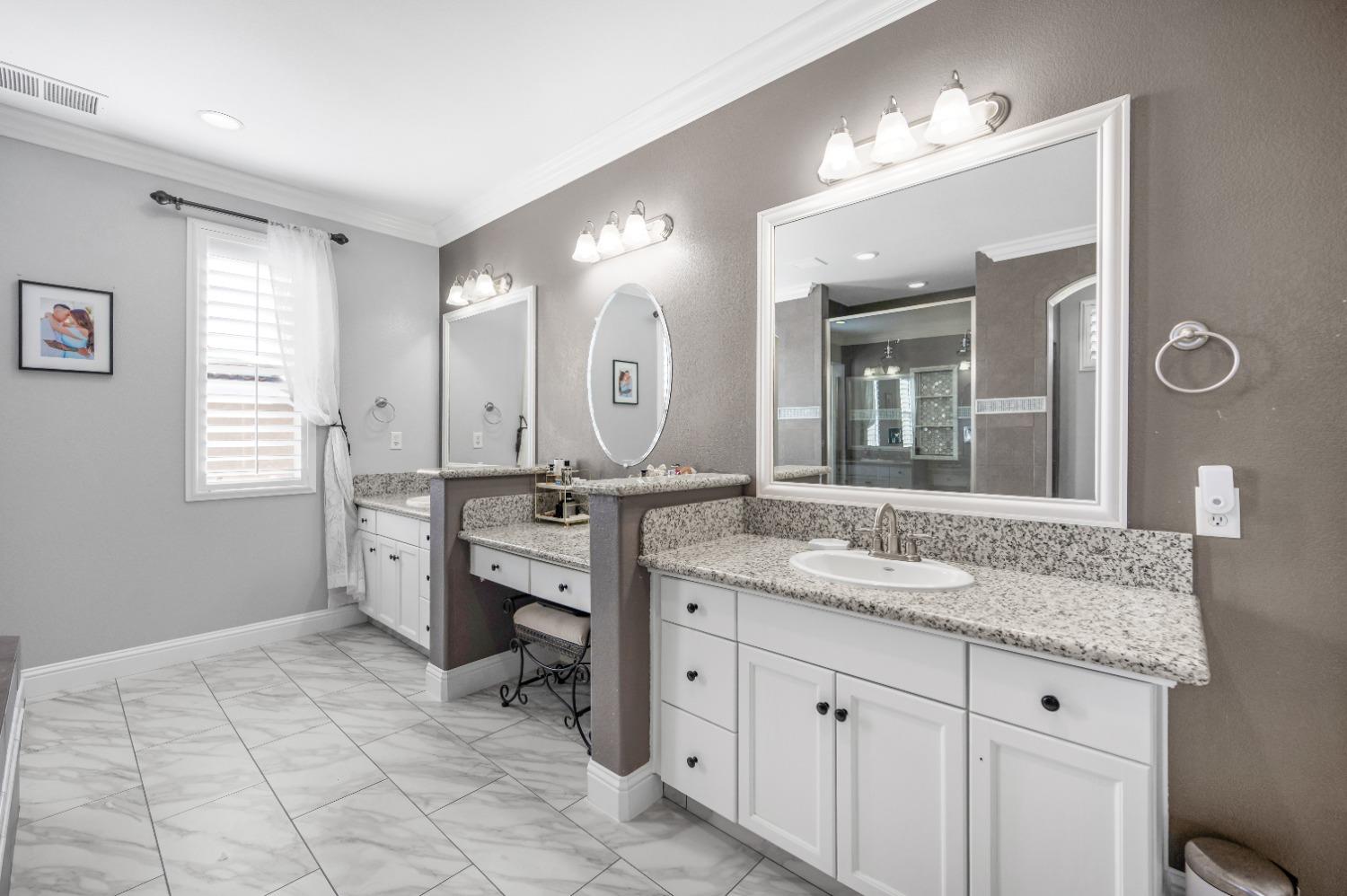 261 North Terry Avenue Clovis, CA 93612 - Photo 35 of 51 a spacious bathroom with a granite countertop sink a mirror and a