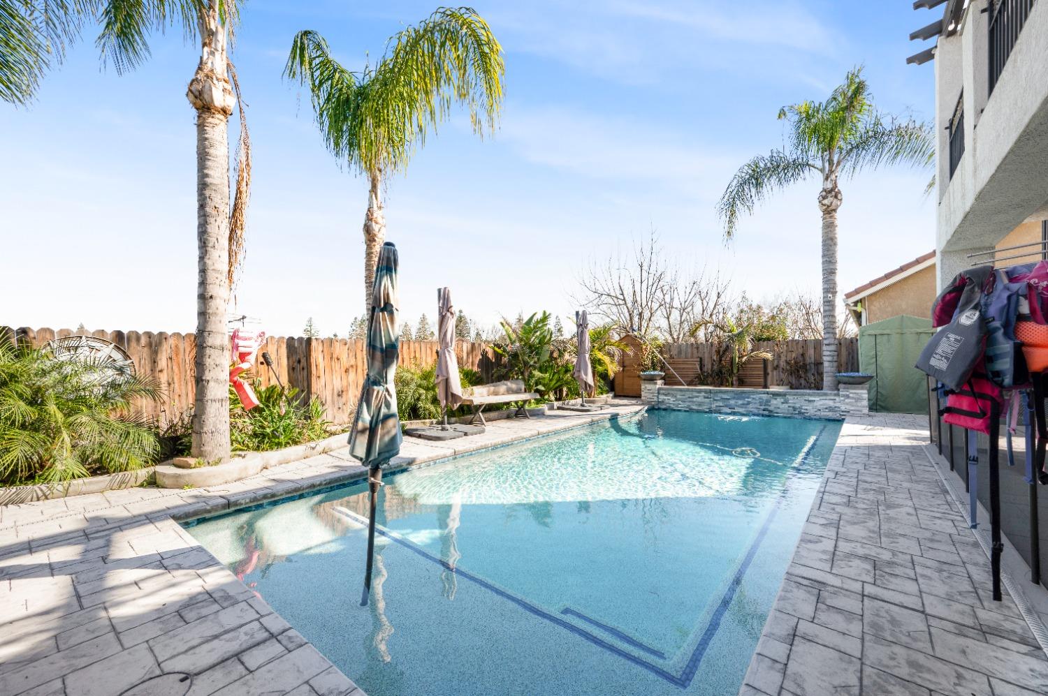 261 North Terry Avenue Clovis, CA 93612 - Photo 45 of 51 a view of a swimming pool with a patio and a garden