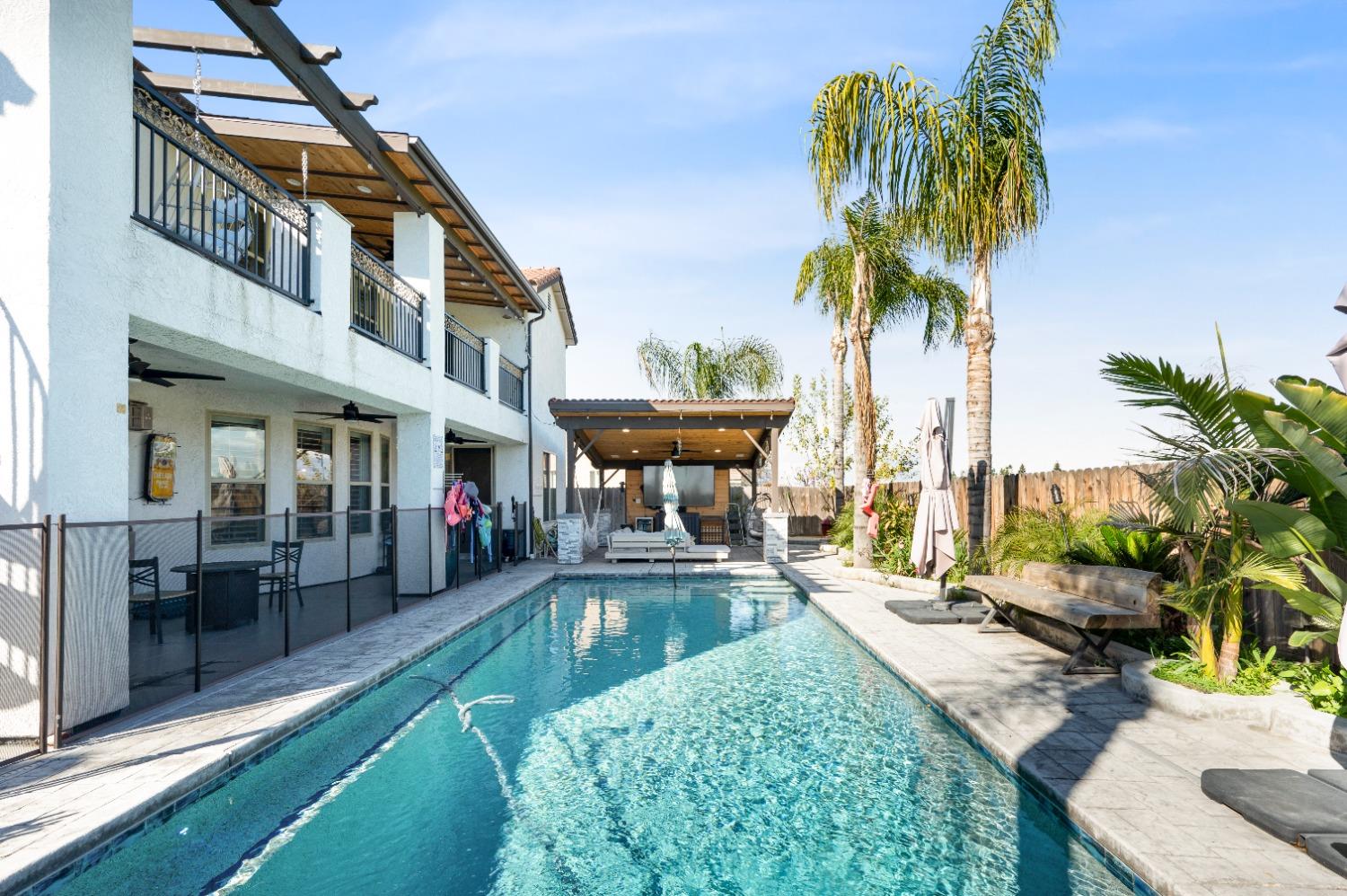 261 North Terry Avenue Clovis, CA 93612 - Photo 49 of 51 a view of a swimming pool with a patio and a yard