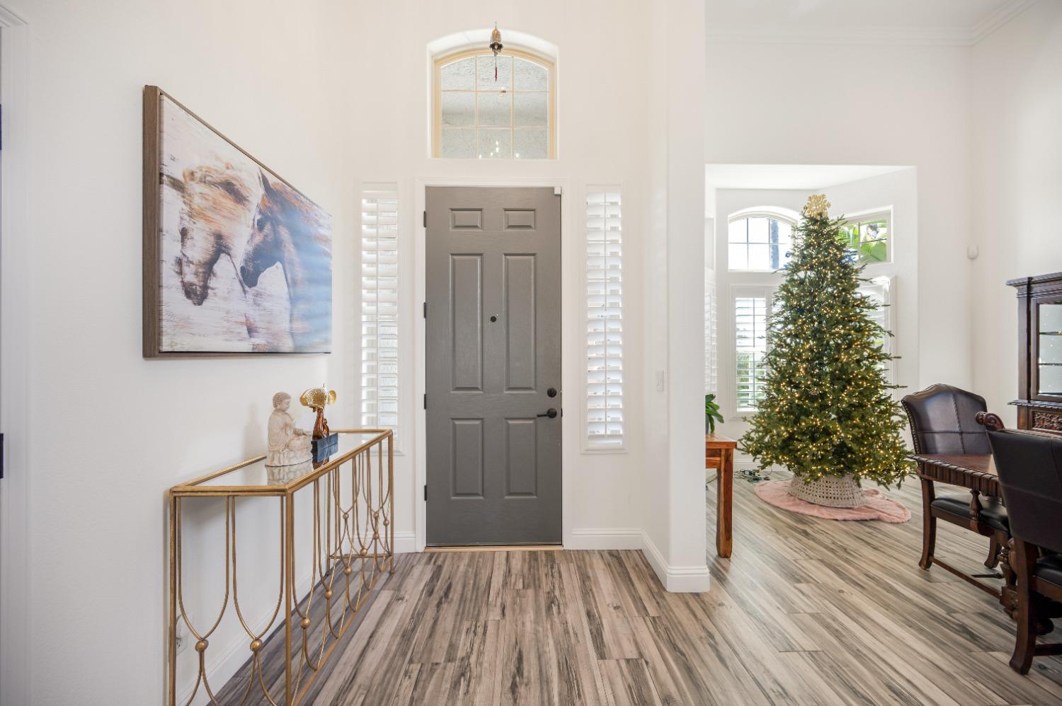 261 North Terry Avenue Clovis, CA 93612 - Photo 6 of 51 a view of a hallway with wooden floor and furniture