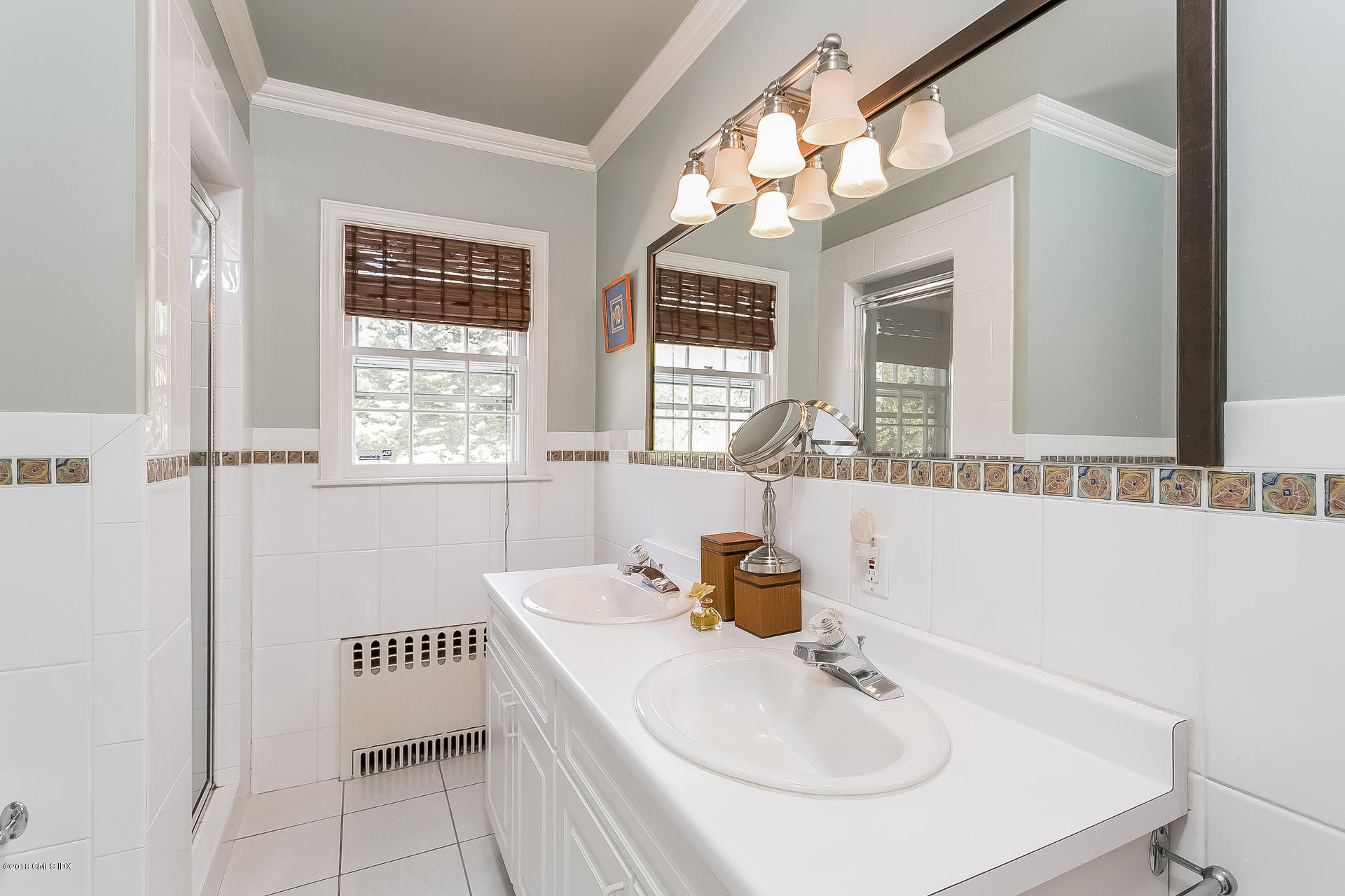 66 Bruce Park Drive Greenwich, CT 06830 - Photo 14 of 27 a bathroom with a sink and a mirror