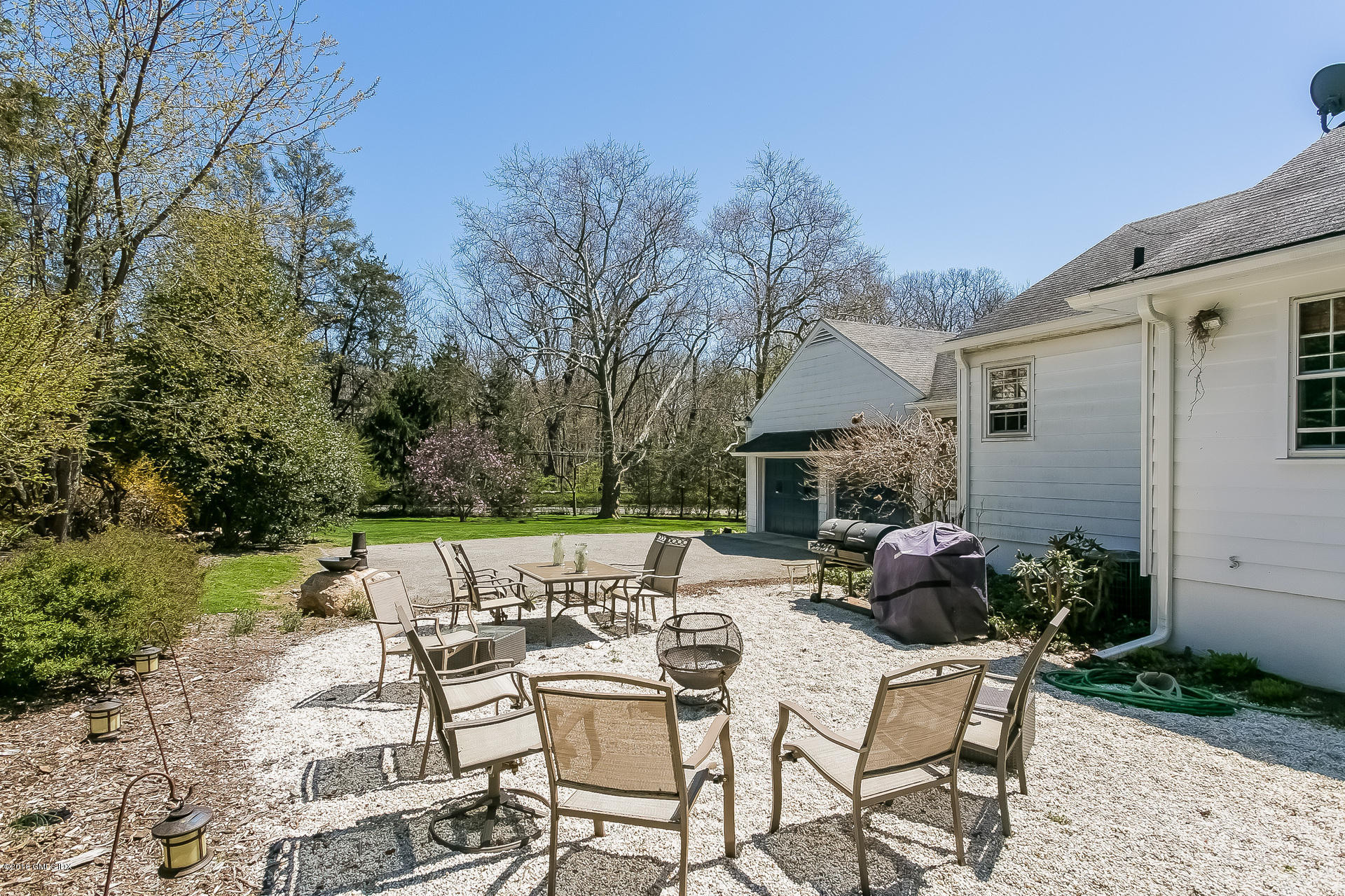 66 Bruce Park Drive Greenwich, CT 06830 - Photo 17 of 27 a swimming pool with outdoor seating and yard