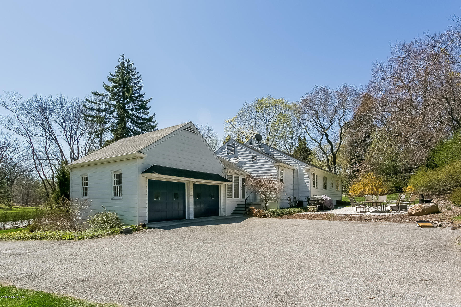 66 Bruce Park Drive Greenwich, CT 06830 - Photo 18 of 27 a view of a house with a yard and large tree