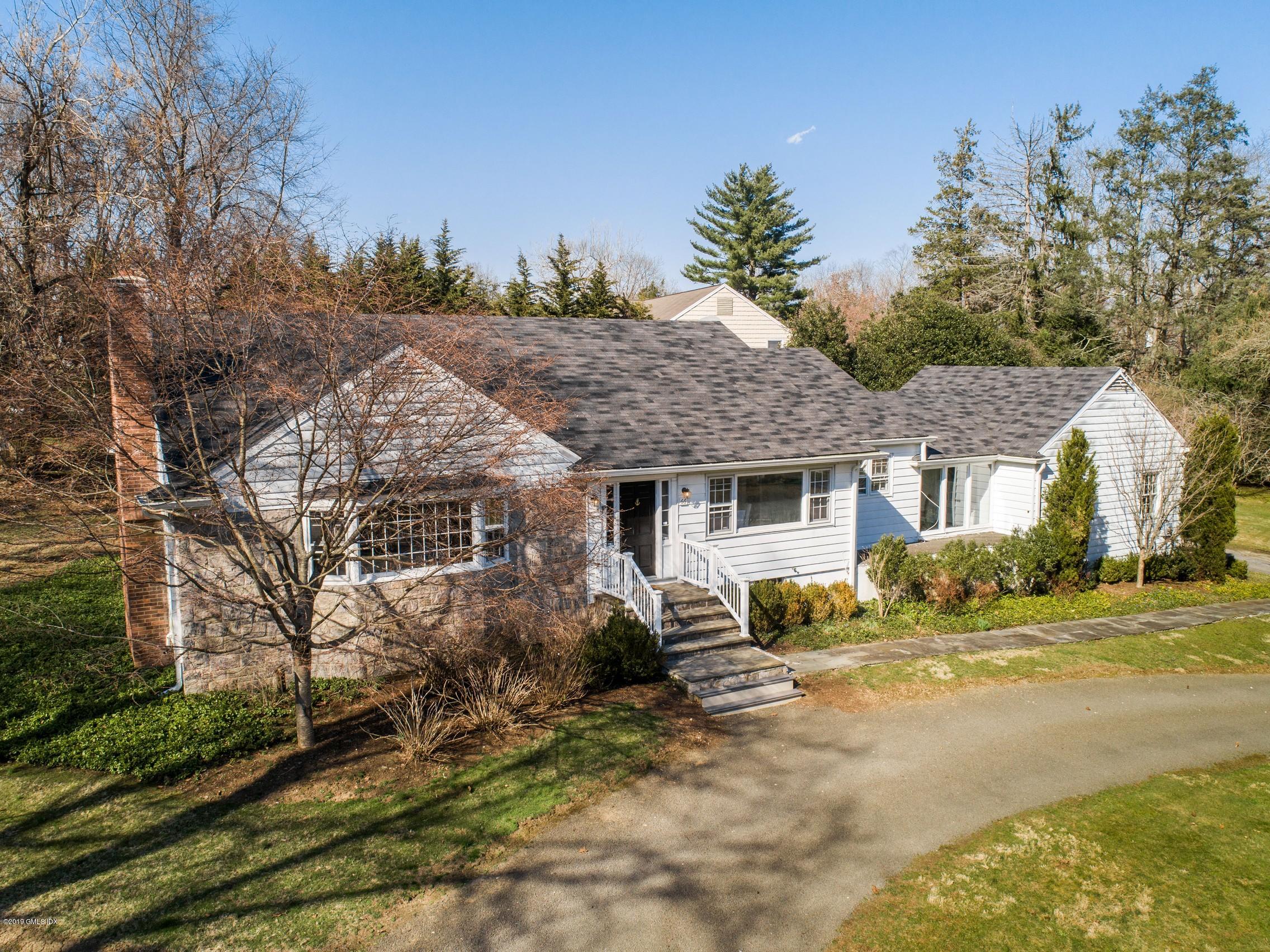 66 Bruce Park Drive Greenwich, CT 06830 - Photo 22 of 27 a view of a house with a yard