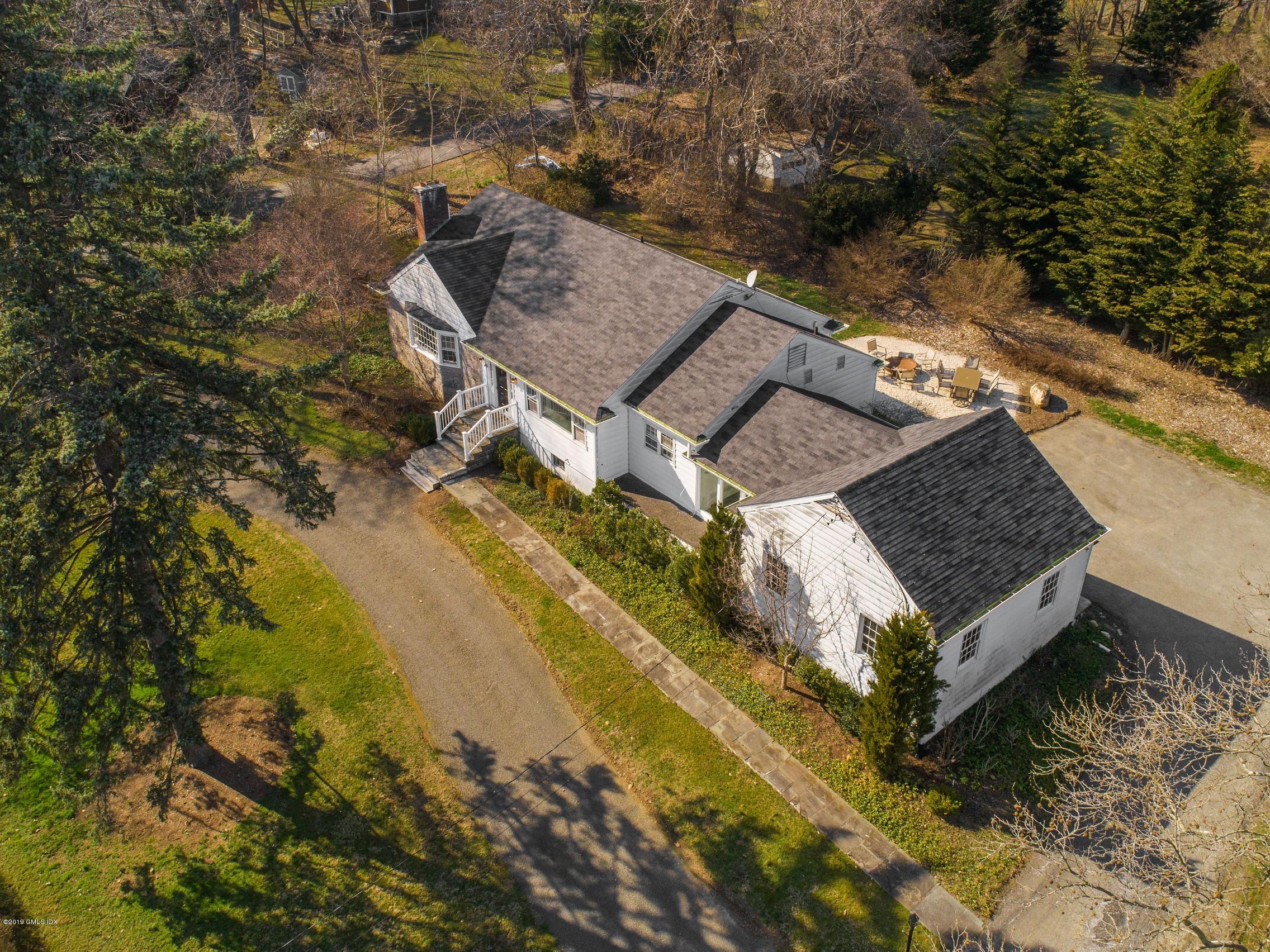 66 Bruce Park Drive Greenwich, CT 06830 - Photo 24 of 27 an aerial view of a house with a yard swimming pool and outdoor seating
