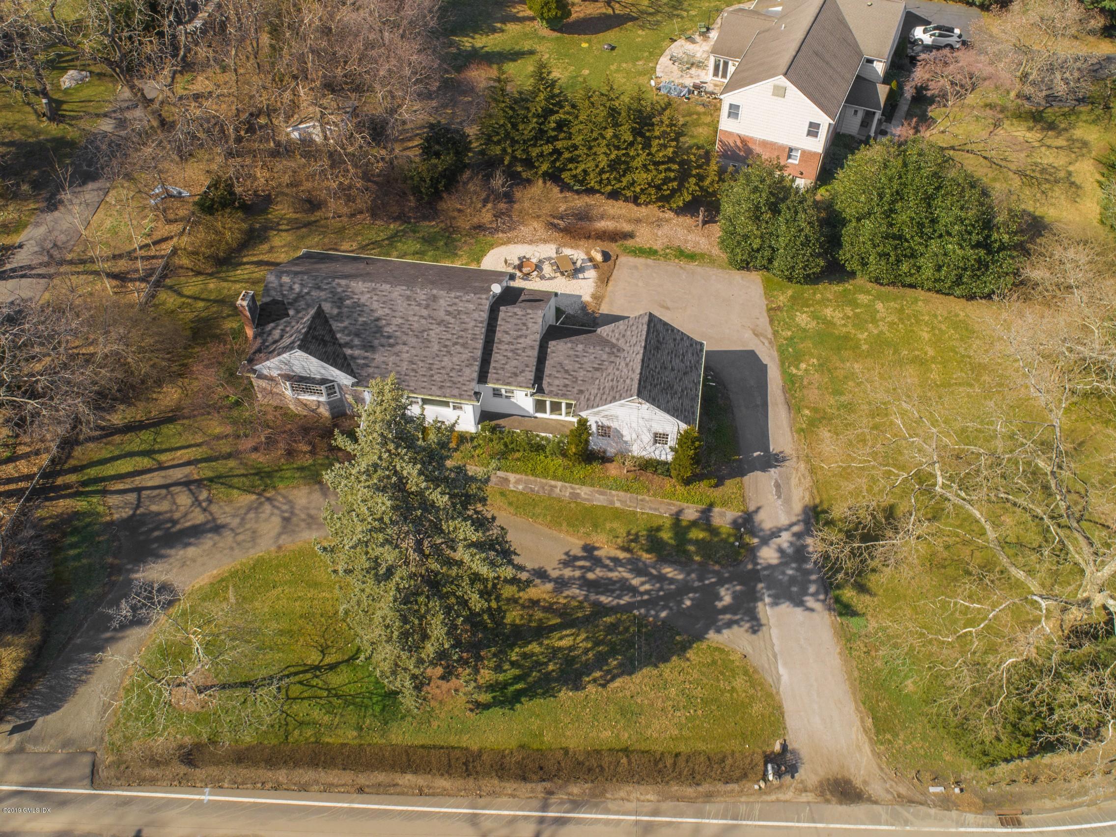 66 Bruce Park Drive Greenwich, CT 06830 - Photo 26 of 27 a view of a house with a yard