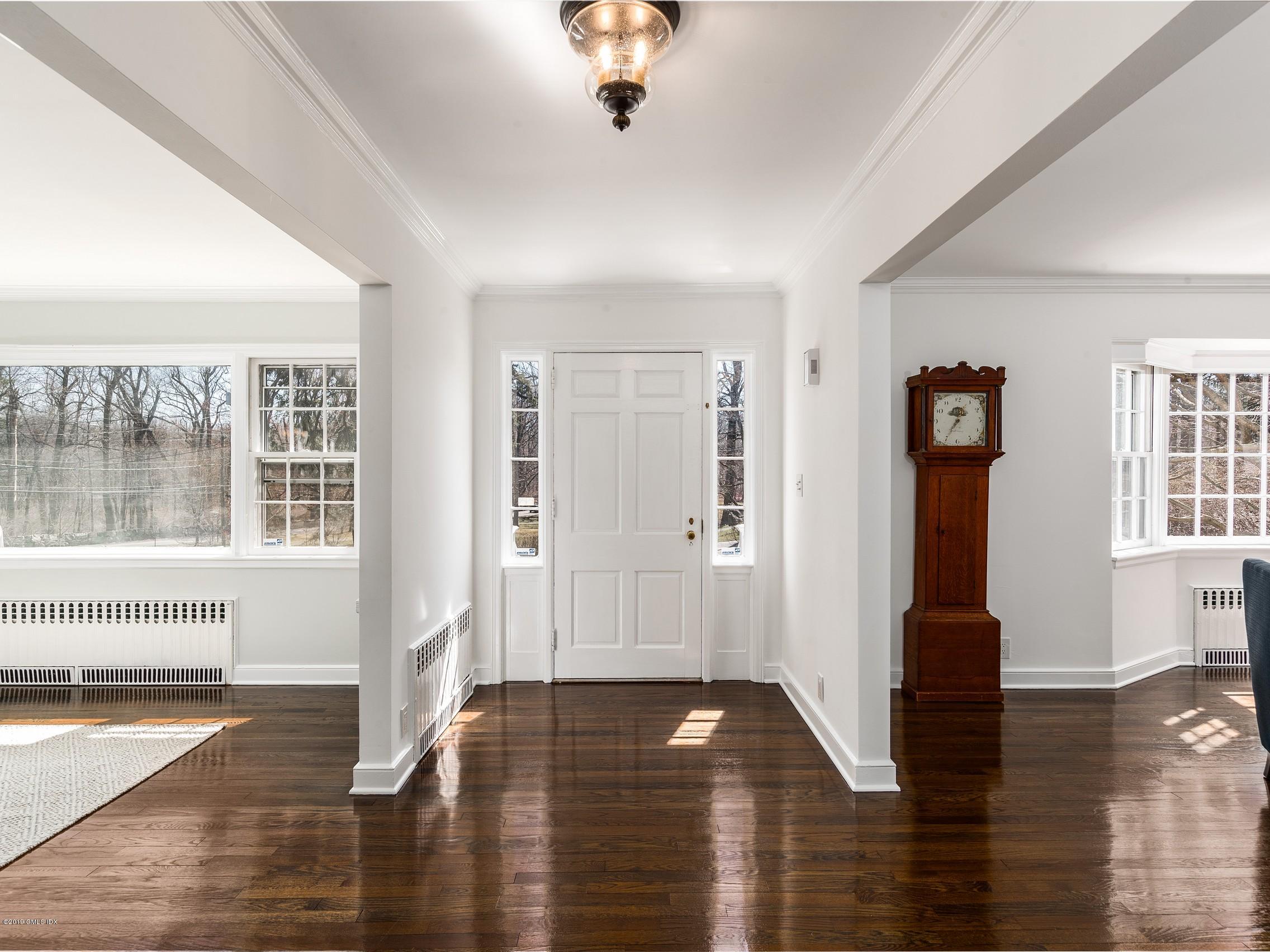 66 Bruce Park Drive Greenwich, CT 06830 - Photo 3 of 27 a view of a hallway with wooden floor and windows
