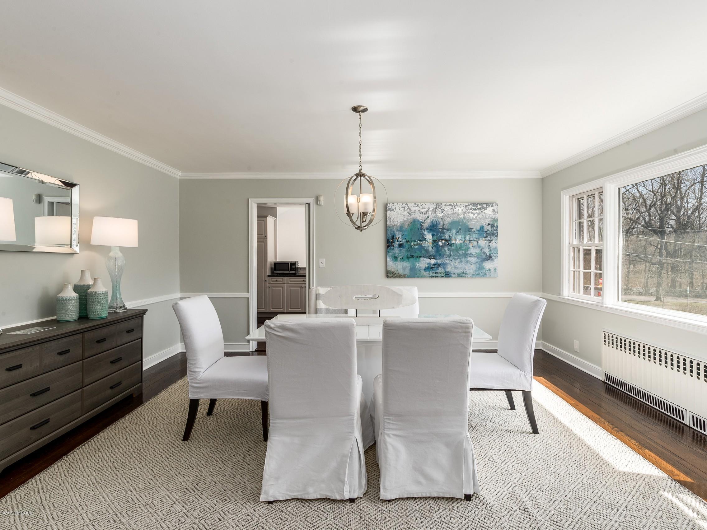 66 Bruce Park Drive Greenwich, CT 06830 - Photo 7 of 27 a view of a dining room with furniture a chandelier and wooden floor
