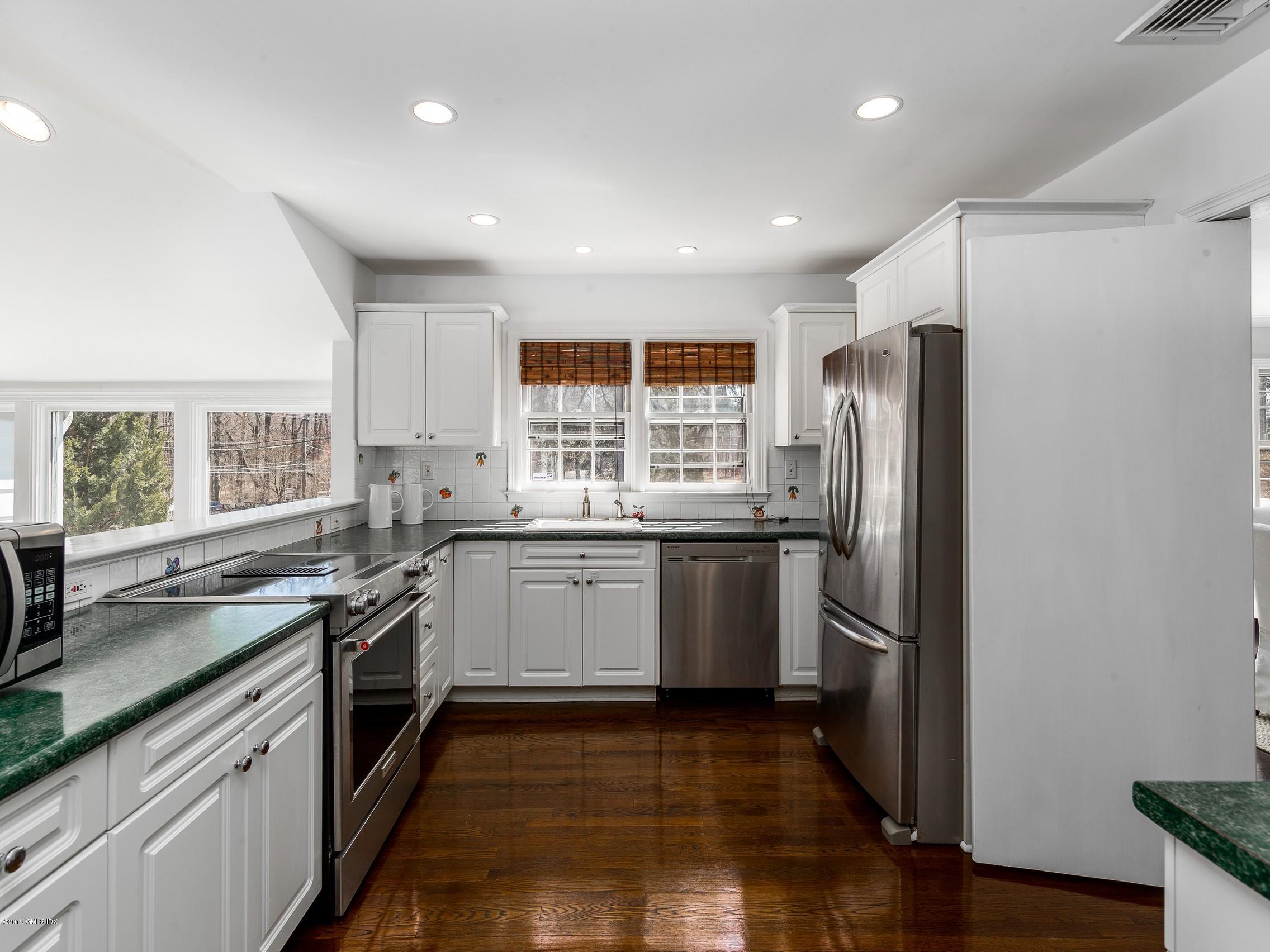 66 Bruce Park Drive Greenwich, CT 06830 - Photo 8 of 27 a kitchen with a refrigerator and a sink