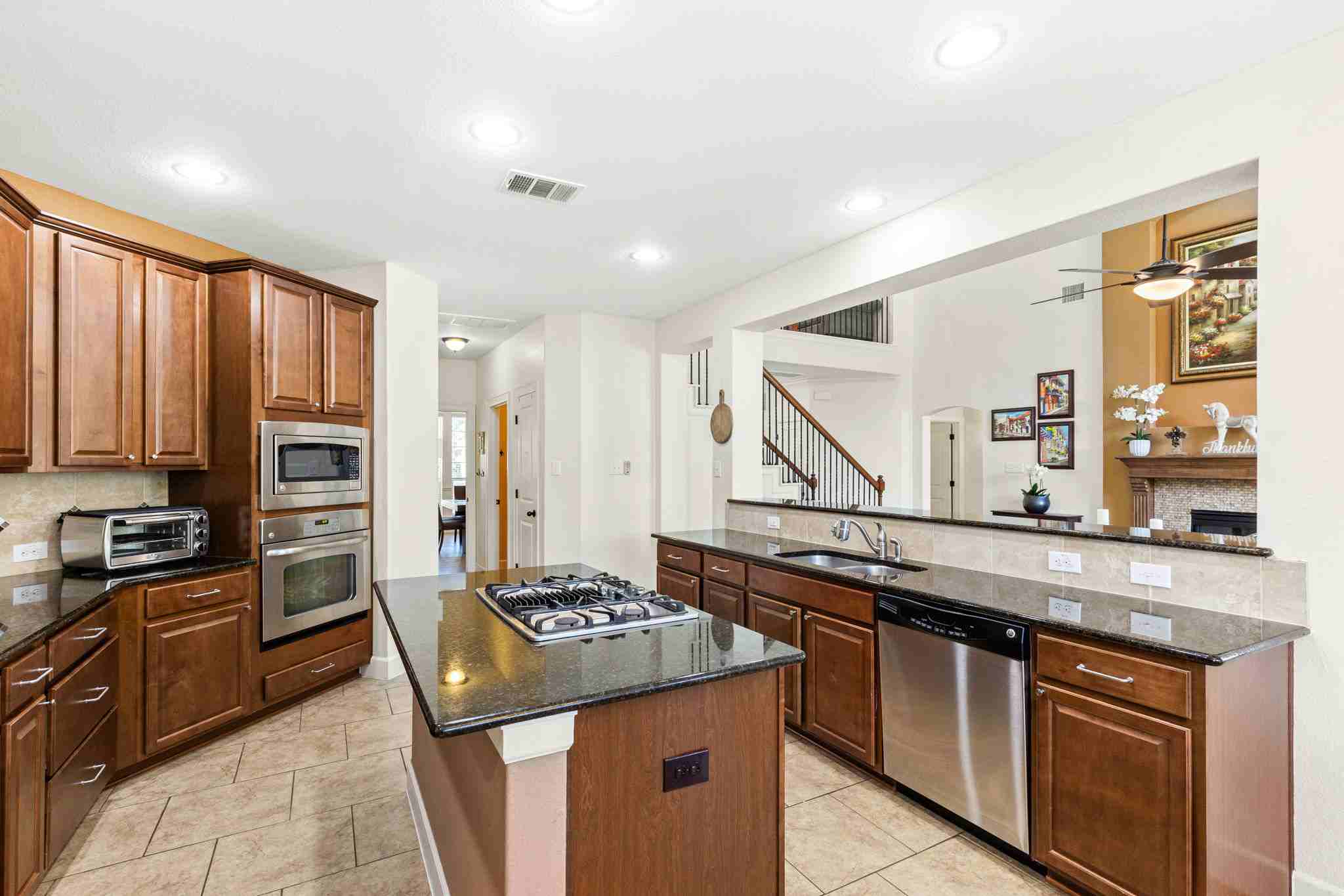 2525 Quick Fort Drive Leander, TX 78641 - Photo 12 of 39 a kitchen with stainless steel appliances granite countertop a stove a sink and a refrigerator