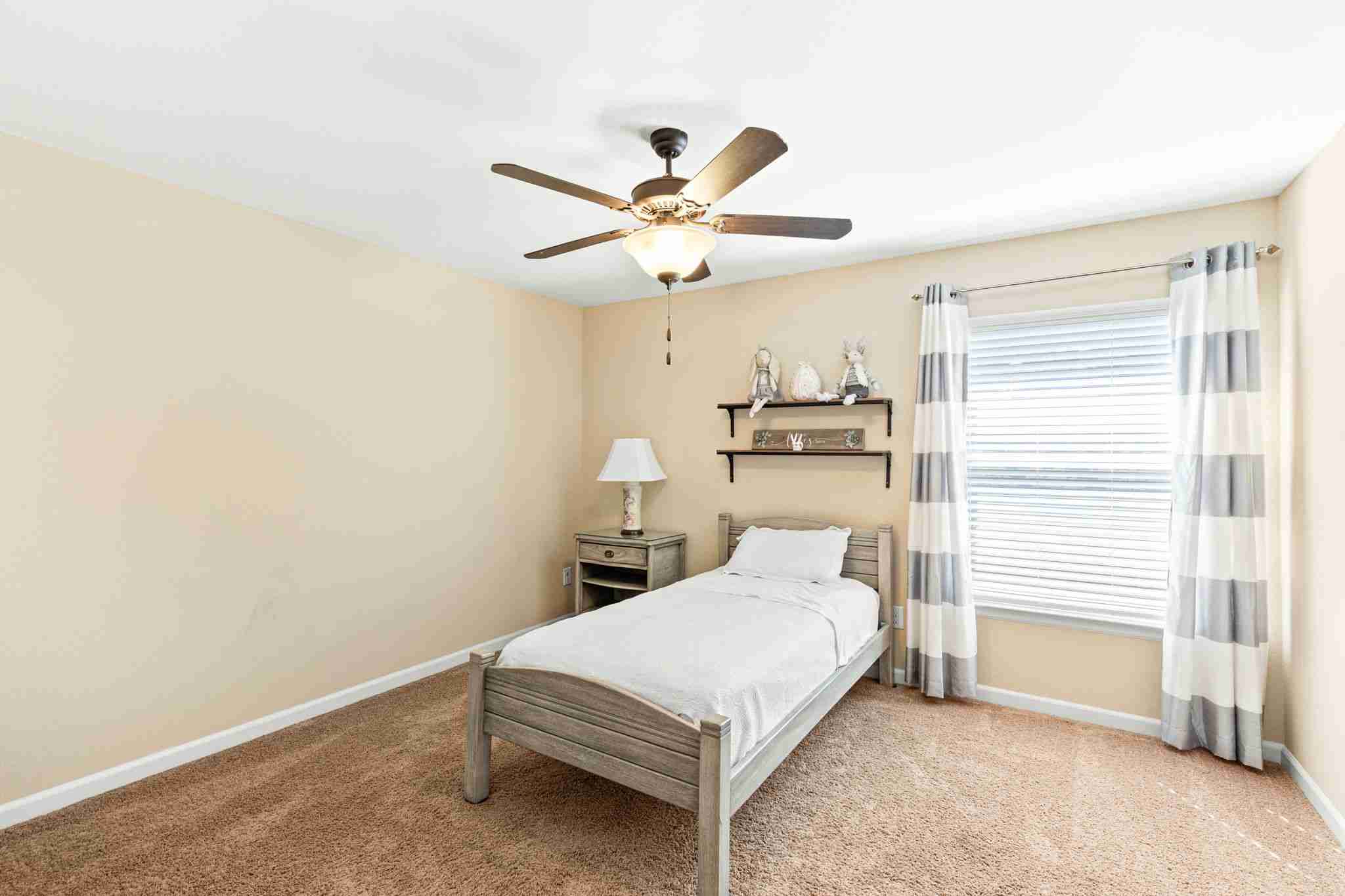 2525 Quick Fort Drive Leander, TX 78641 - Photo 27 of 39 a bedroom with a bed and a ceiling fan