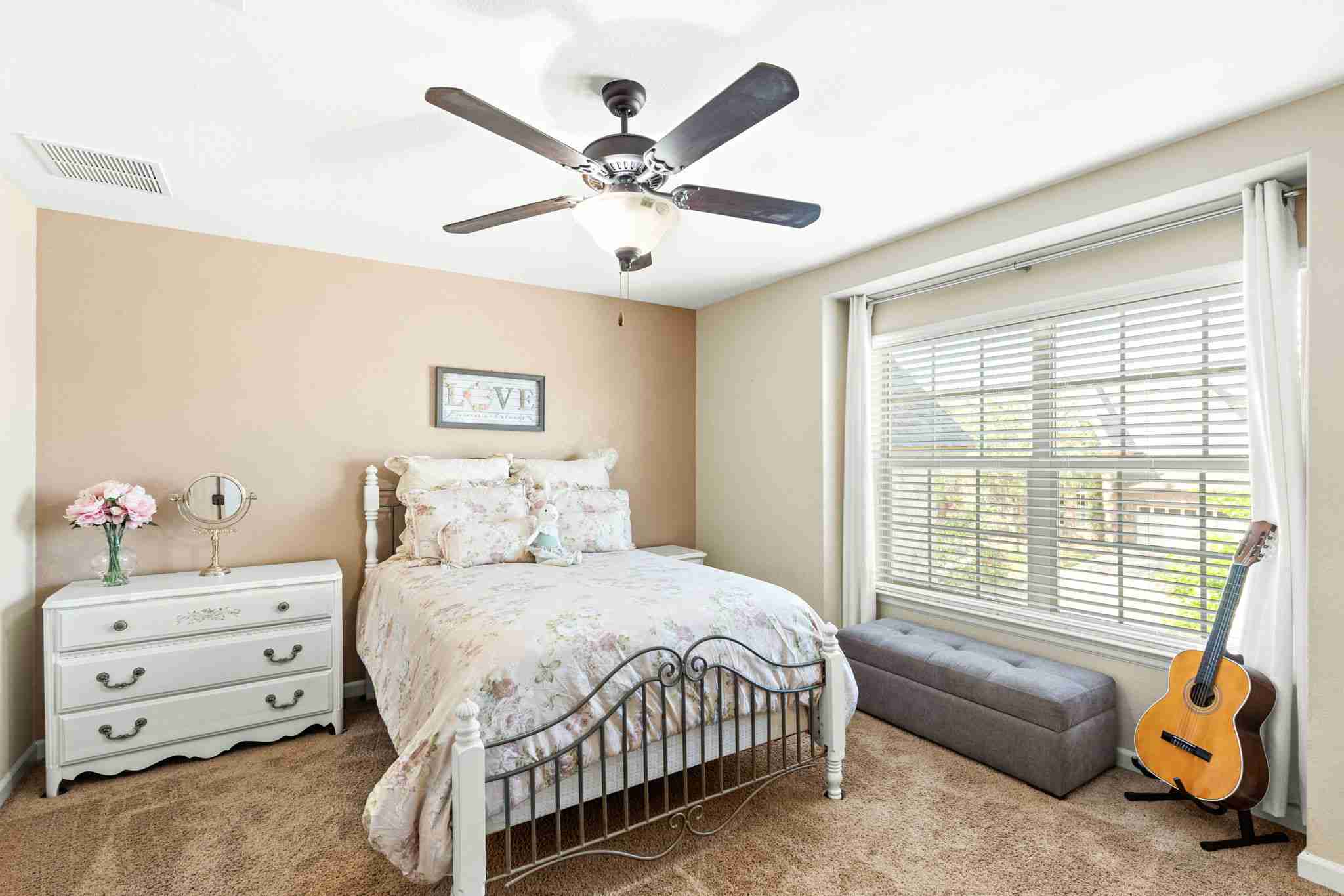 2525 Quick Fort Drive Leander, TX 78641 - Photo 30 of 39 a bedroom with a bed and a chandelier