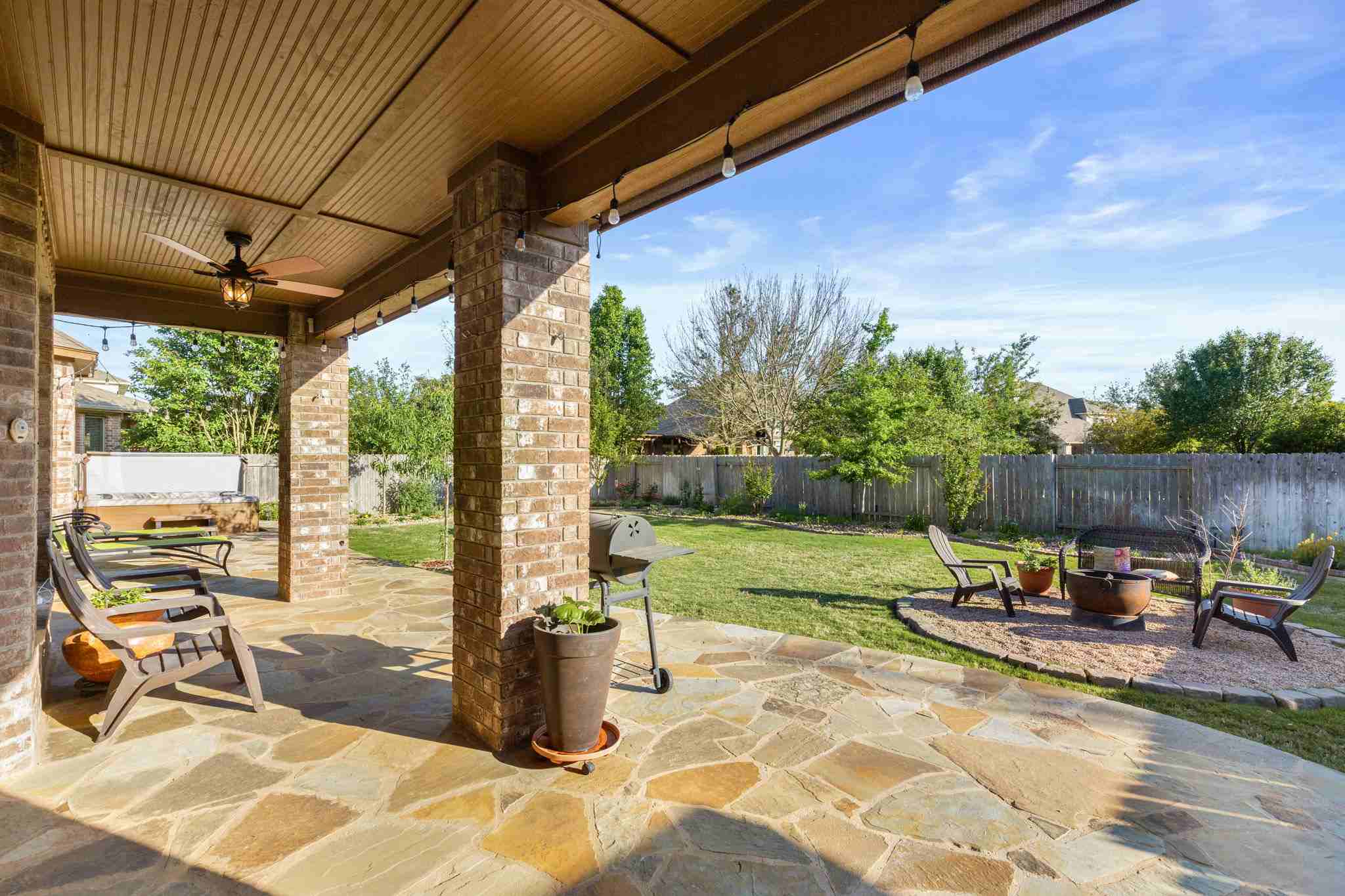 2525 Quick Fort Drive Leander, TX 78641 - Photo 31 of 39 a view of a patio with table and chairs potted plants with wooden floor
