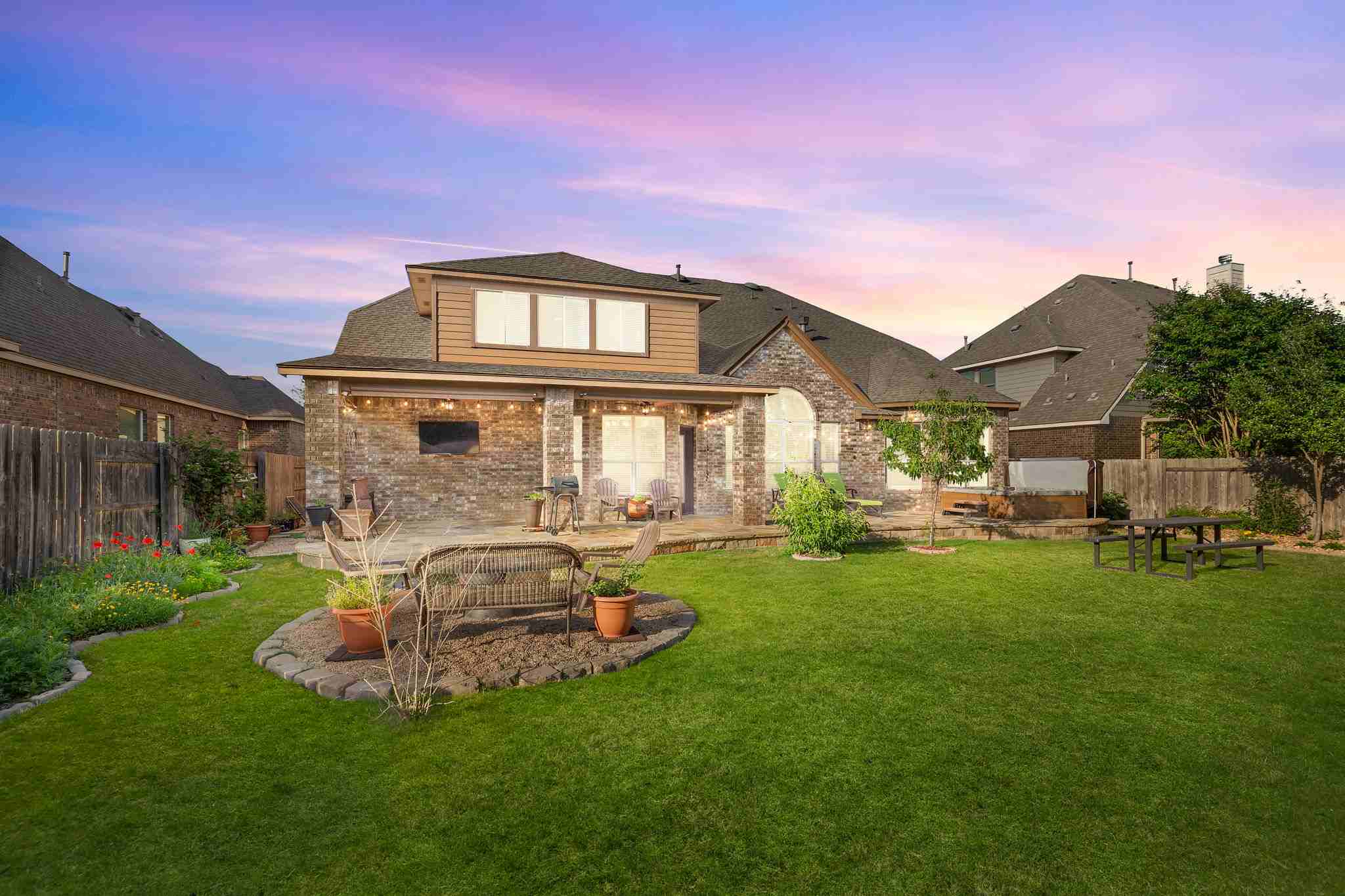 2525 Quick Fort Drive Leander, TX 78641 - Photo 37 of 39 a front view of a house with a yard fire pit and outdoor seating
