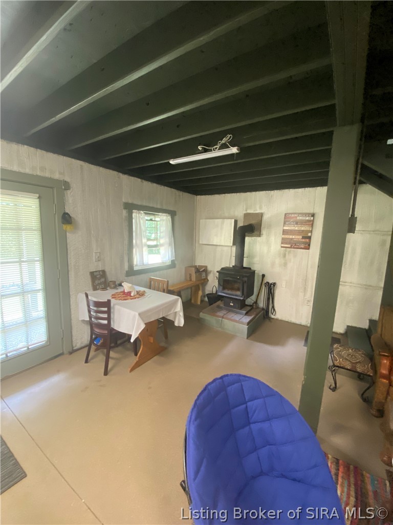 6024 Little Patoka Road Taswell, IN 47175 - Photo 12 of 33 Main floor. view of wood burning stove and a/c unit is in wooden box to left.