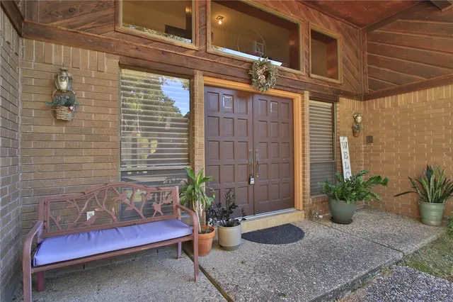 a view of a porch with potted plants