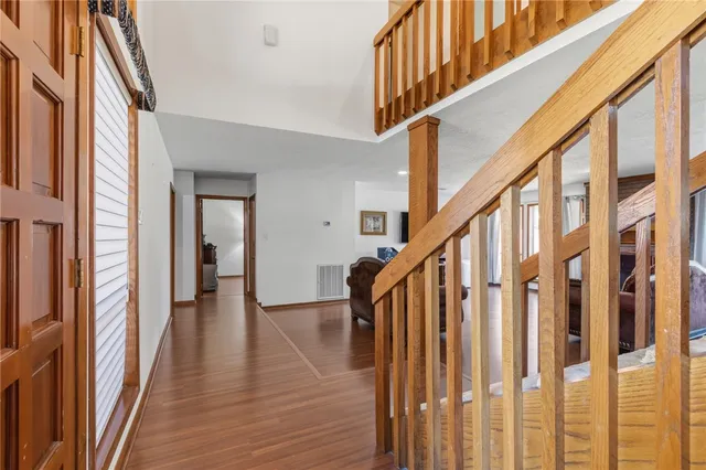 a view of an entryway with wooden floor and stairs