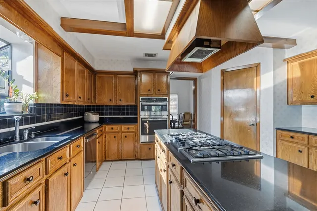 a kitchen with a stove and a refrigerator
