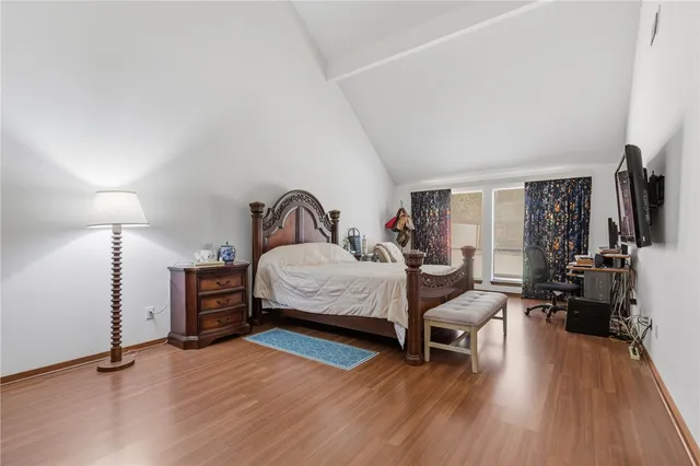 a bedroom with furniture and a wooden floor