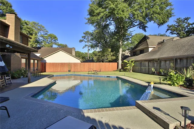 a view of a swimming pool with lounge chair