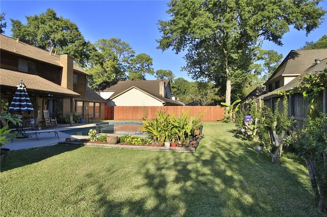 a view of a backyard with plants and a patio