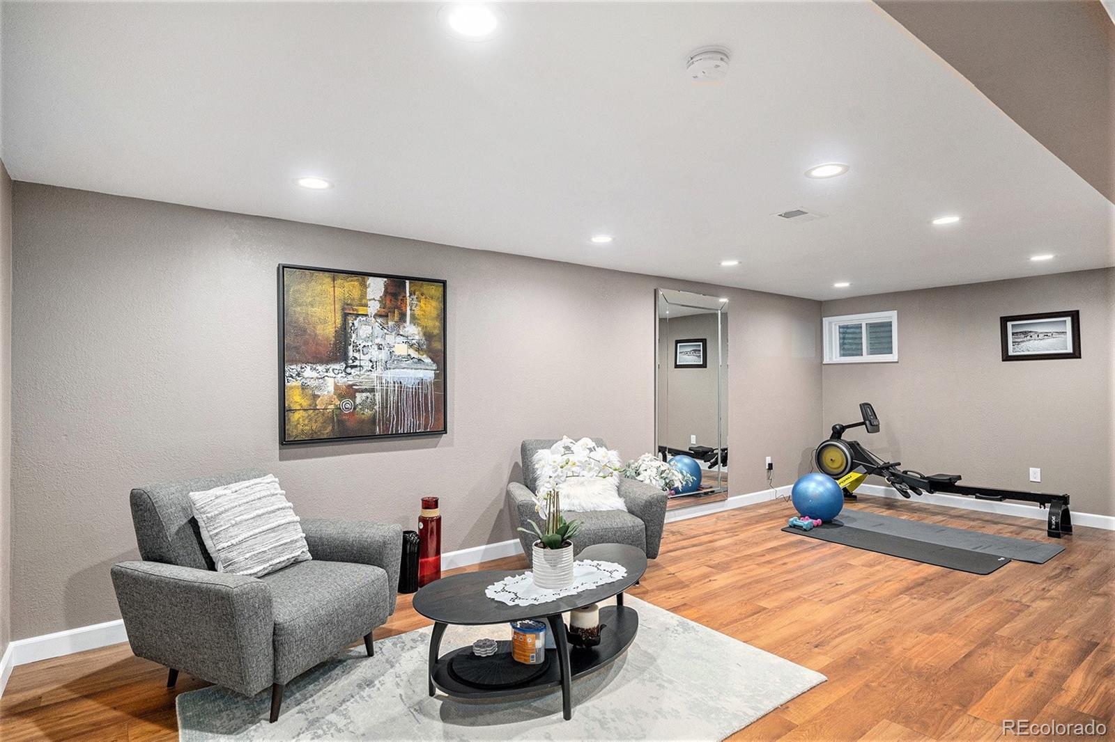 904 Fieldstone Place Highlands Ranch, CO 80126 - Photo 16 of 28 a living room with furniture and a gym