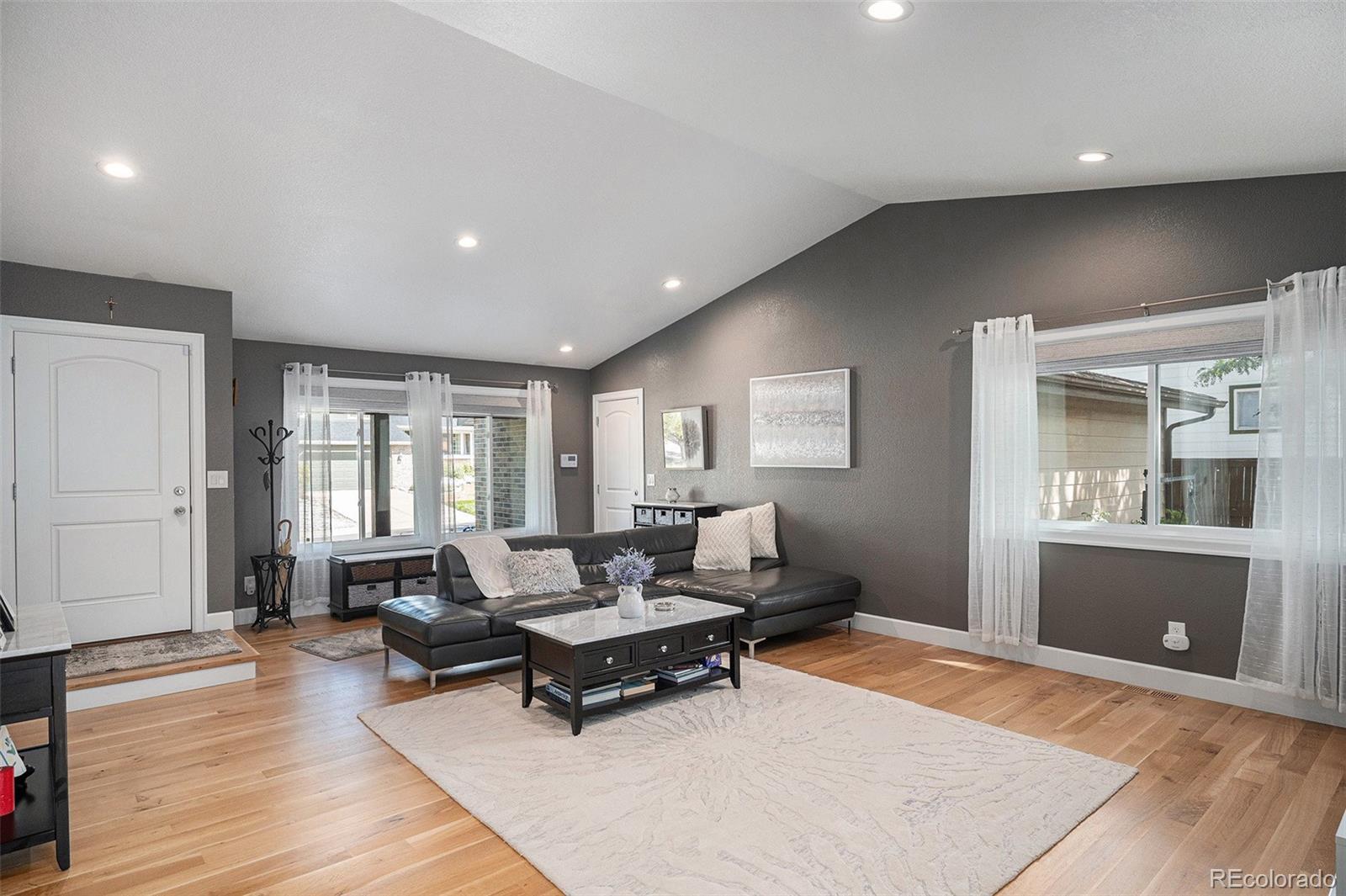 904 Fieldstone Place Highlands Ranch, CO 80126 - Photo 4 of 28 a living room with furniture and wooden floor
