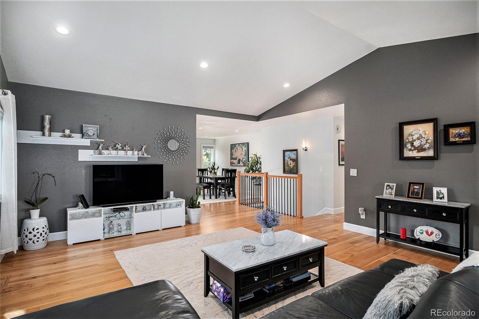 904 Fieldstone Place Highlands Ranch, CO 80126 - Photo 5 of 28 a living room with furniture and a flat screen tv