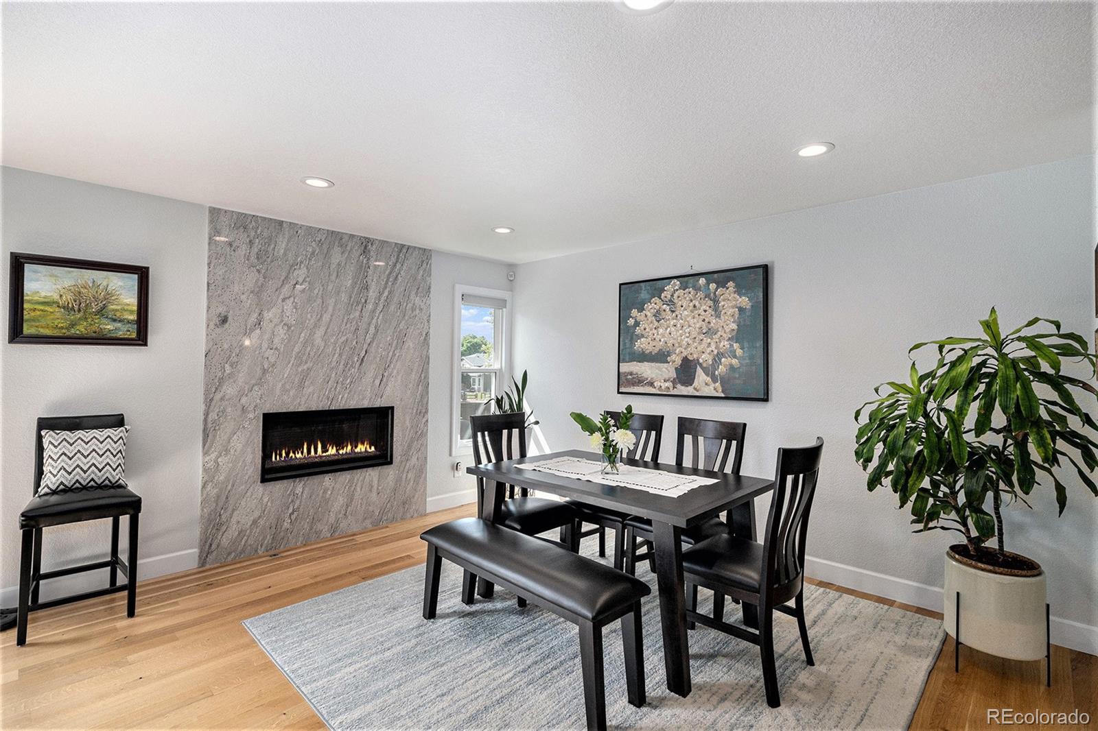904 Fieldstone Place Highlands Ranch, CO 80126 - Photo 6 of 28 a dining room with furniture and a fireplace