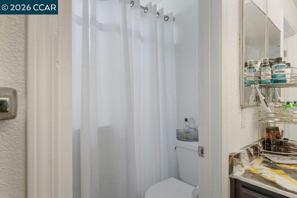 645 Anderson Way Rio Vista, CA 94571 - Photo 12 of 47 a bathroom with a granite countertop sink toilet and shower