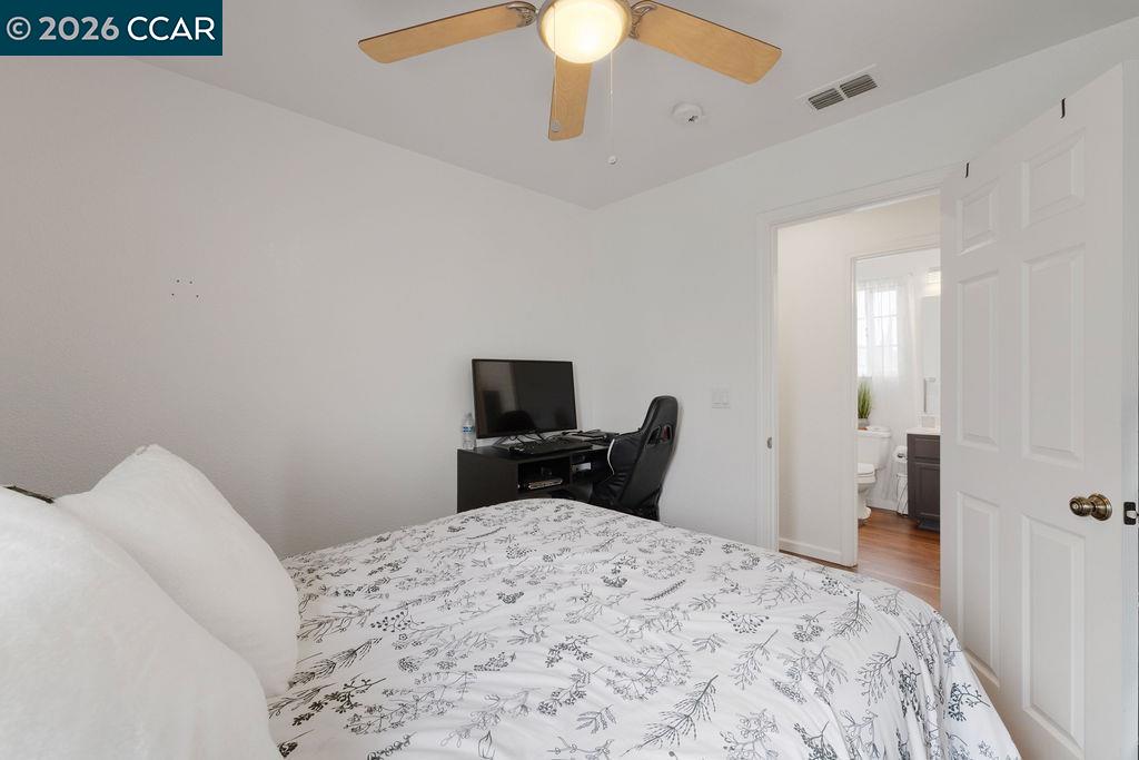 645 Anderson Way Rio Vista, CA 94571 - Photo 22 of 47 a bedroom with a bed and a chandelier